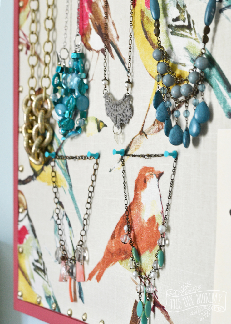 How to make a covered bulletin board with paint, fabric and brass upholstery tacks.