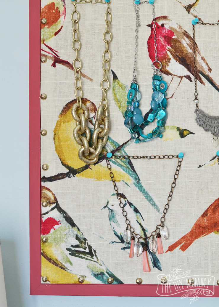 How to make a covered bulletin board with paint, fabric and brass upholstery tacks.
