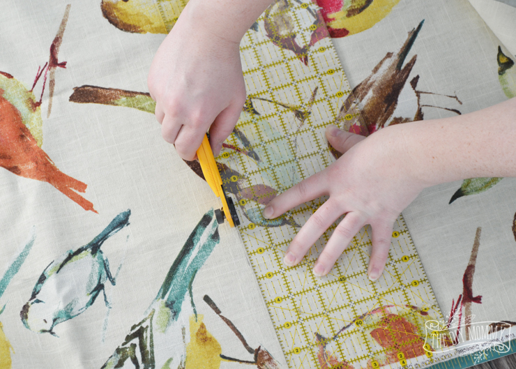 How to make a covered bulletin board with paint, fabric and brass upholstery tacks.