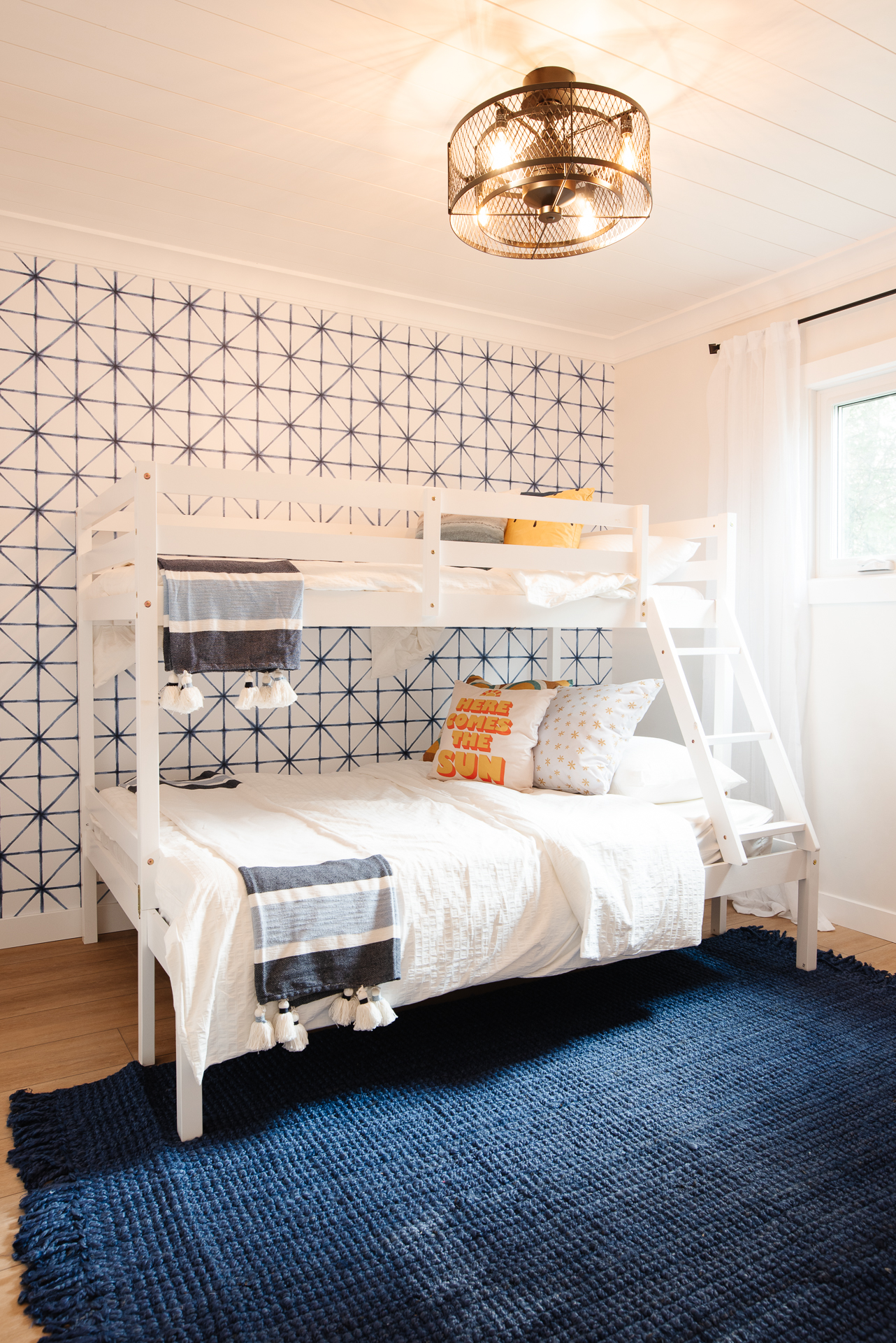 Come see how a plain, dated bedroom was transformed into a bright and cheerful bedroom with a bunk bed and blue, yellow and white colors